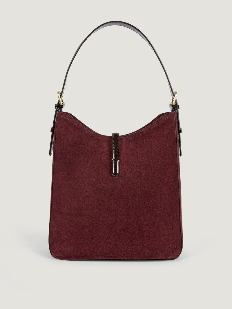COMPTOIR plum calfskin messenger bag worn on a model by Rouje