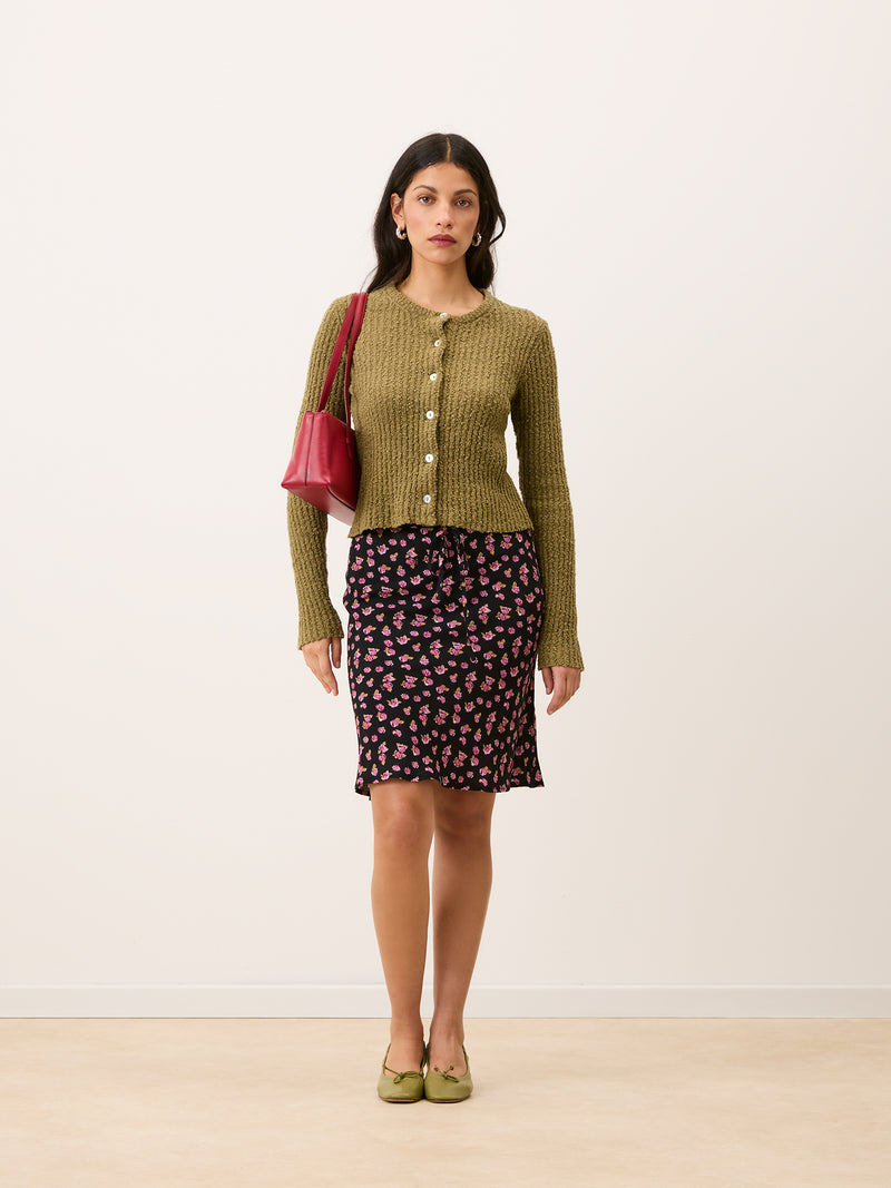 LOICA almond green short ribbed cardigan, detail of mother-of-pearl buttons by Rouje