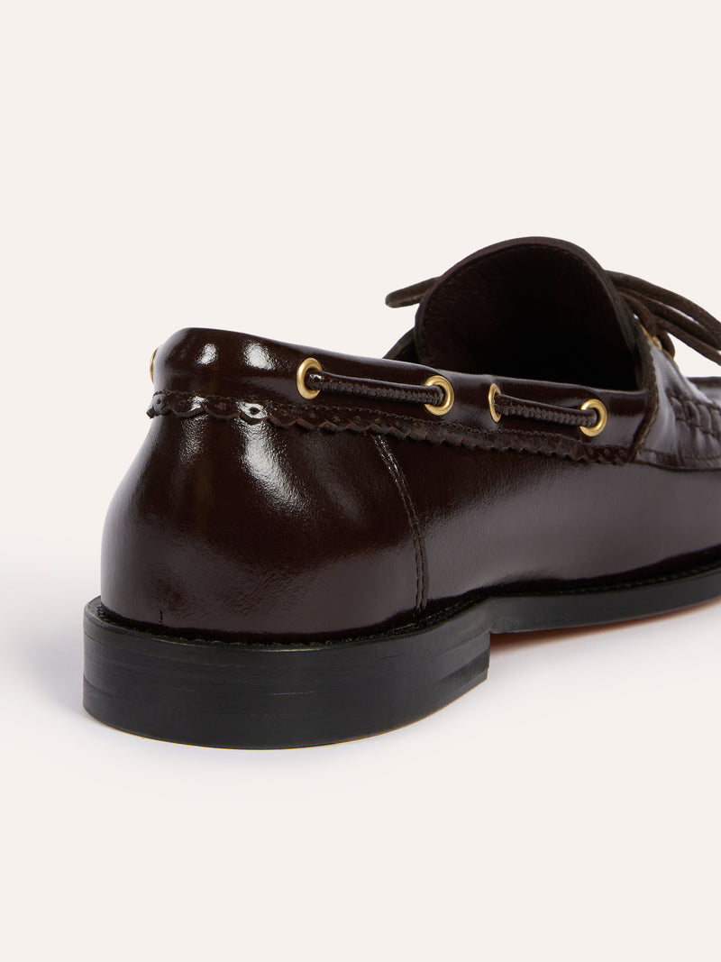 MOC coffee patent leather loafers worn on a model by Rouje