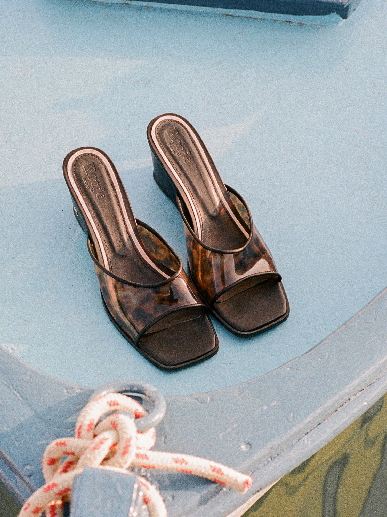 Natty black tortoiseshell mules, lifestyle setting