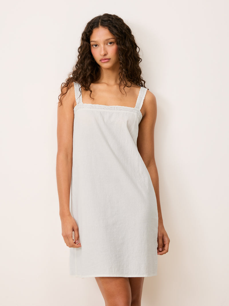 Rachel white short cotton voile strap dress worn by a model, front view
