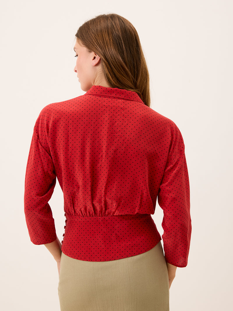 SILVIA red plumetis crossover blouse worn on a model by Rouje