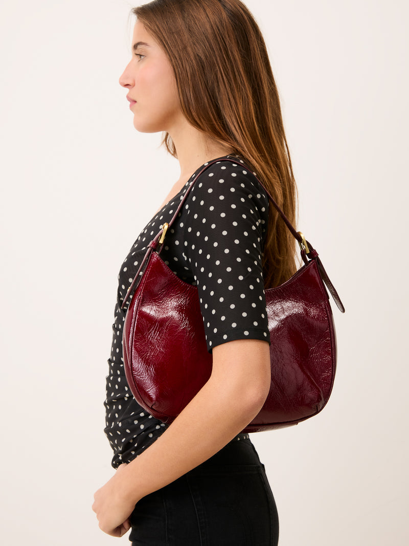 YURA black polka-dot mesh wrap top, detail of ruffles by Rouje